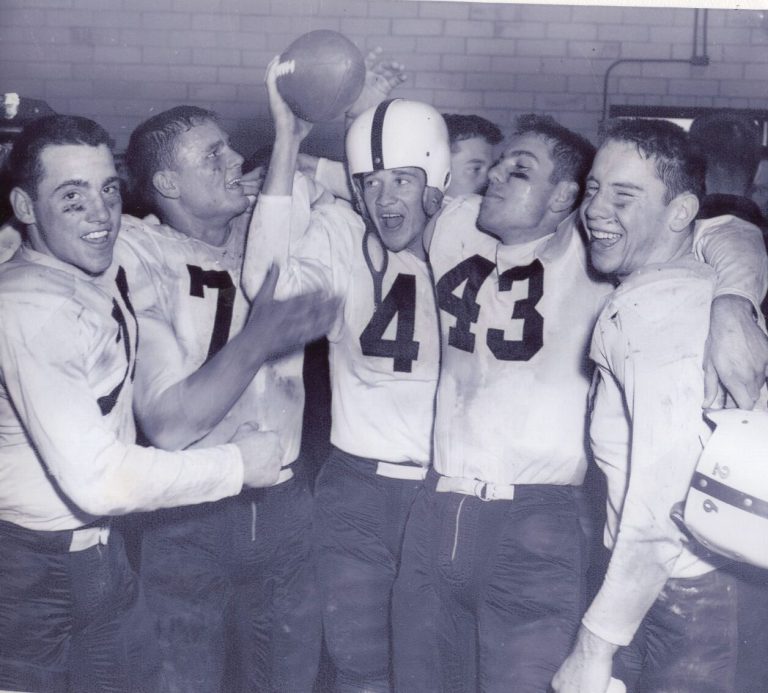 1952 Lubbock State Championship Football Team players in dirt-smudged white jerseys celebrating, one raising a football