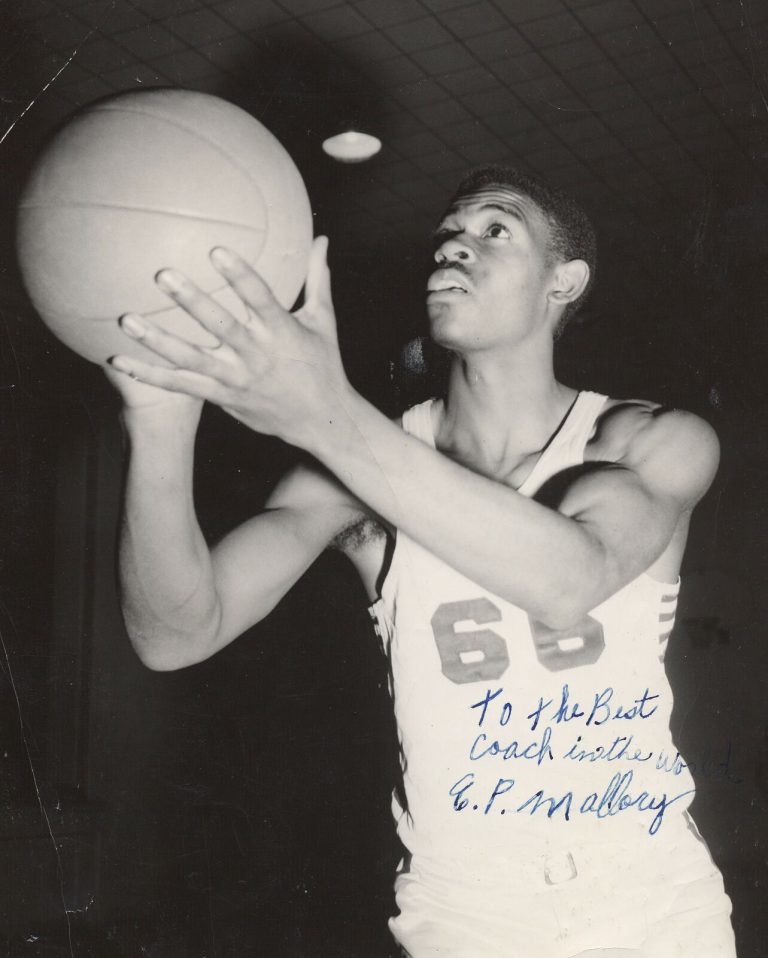 1957 Dunbar State Championship Basketball Team player holding a basketball in a portrait inscribed to Coach E.P. Mallory