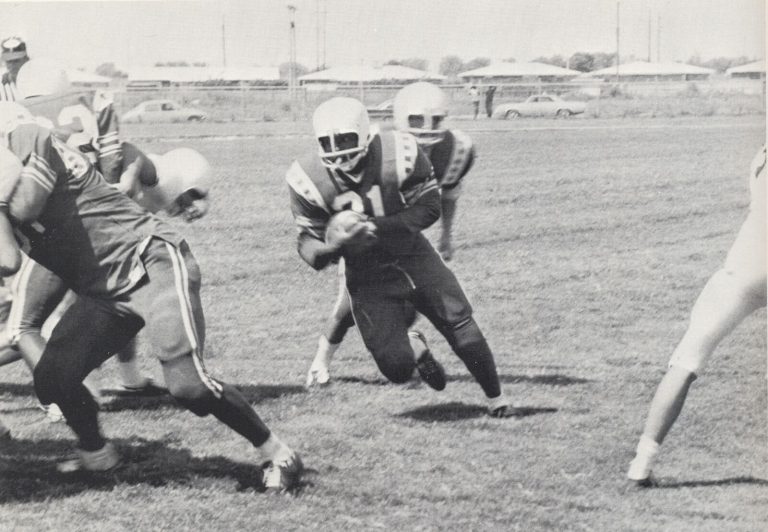 1968 Estacado Matadors Football player Marvin Turner, number 21, carrying the ball toward a gap in the Lubbock High line