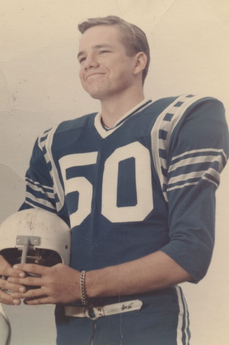1968 Estacado Matadors Football player Joe Rose in a number 50 jersey holding a helmet and smiling