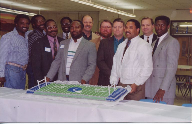 Group of men posing behind a football field cake lettered Estacado and Matadors, 1968 Estacado Matadors Football collection