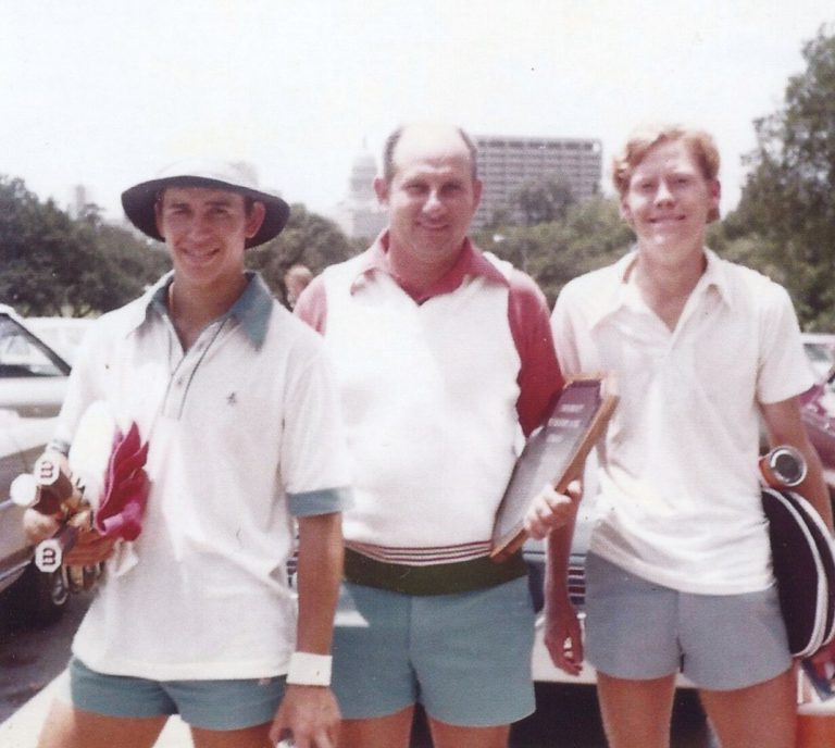 1975 Coronado 4A State Champion Boys Doubles Tennis Team: two young men in tennis whites and a man holding a plaque