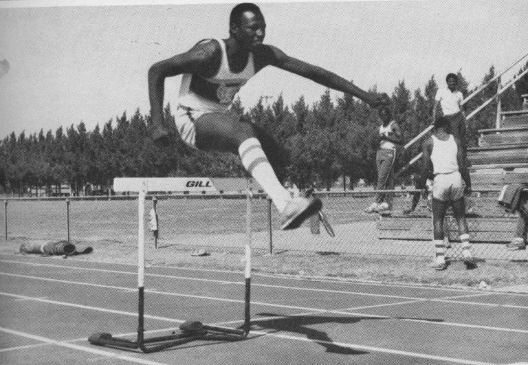 1983 Estacado High School Boys Track and Field State Champions hurdler James Collins clearing a hurdle in practice