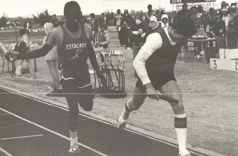 1983 Estacado High School Boys Track and Field State Champions runners with batons reaching a relay finish line
