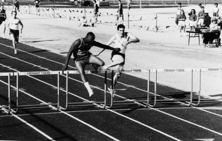 1983 Estacado High School Boys Track and Field State Champions hurdlers racing over hurdles at a track meet