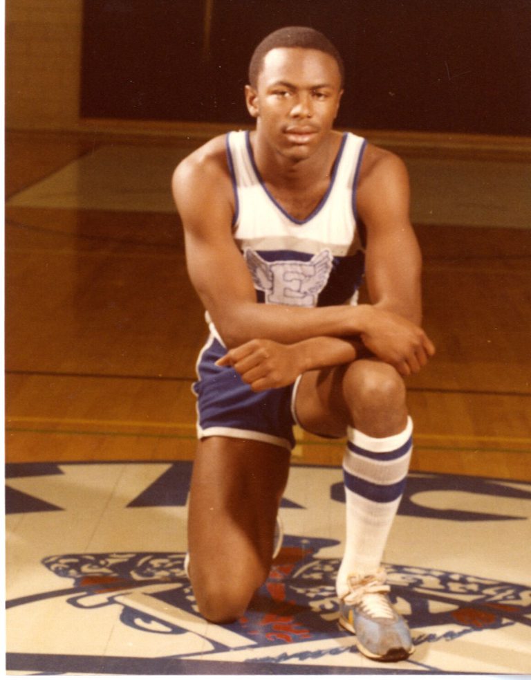 1983 Estacado High School Boys Track and Field State Champions athlete kneeling with arms crossed in a winged E uniform