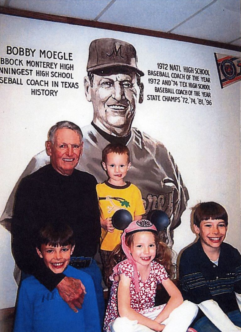 Bobby Moegle with four children in front of a Monterey High baseball mural bearing the name Bobby Moegle