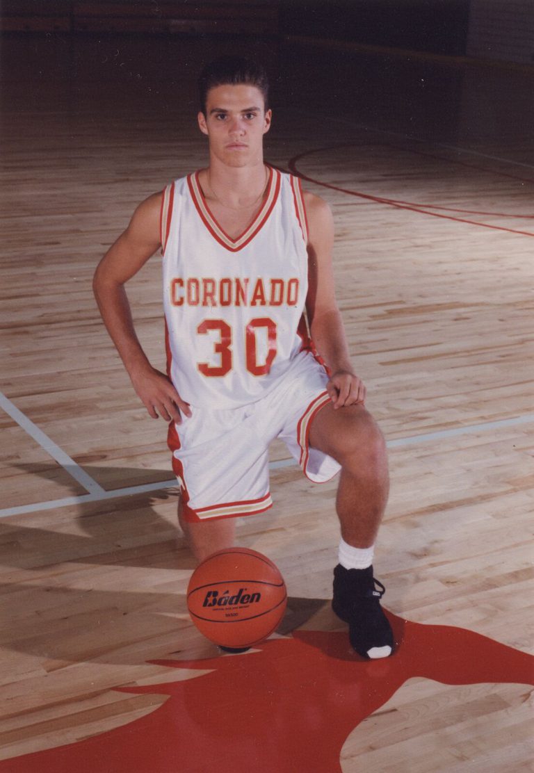 Brad Ralston kneeling with a basketball in a Coronado number 30 basketball jersey