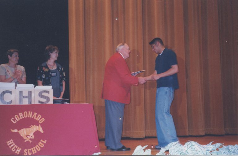 Cal Lowry presenting an award on the Coronado High School stage