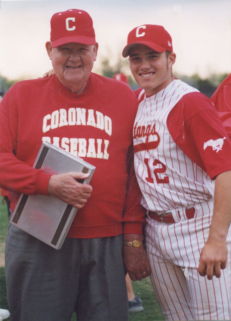 Cal Lowry in a Coronado Baseball sweatshirt with a Mustangs player in a number 12 jersey