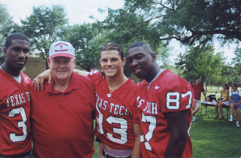 Cal Lowry with three Texas Tech football players at an outdoor event