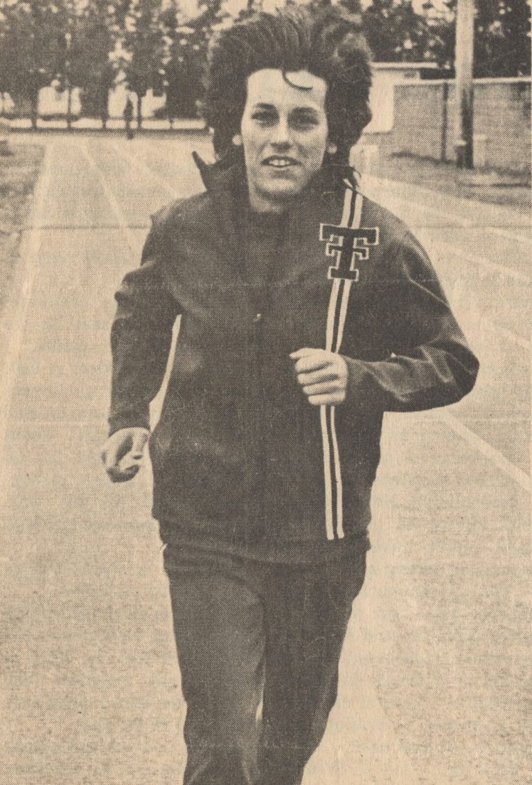Caylene Caddell jogging on a track in a Texas Tech jacket, from a newspaper story on the women's track team