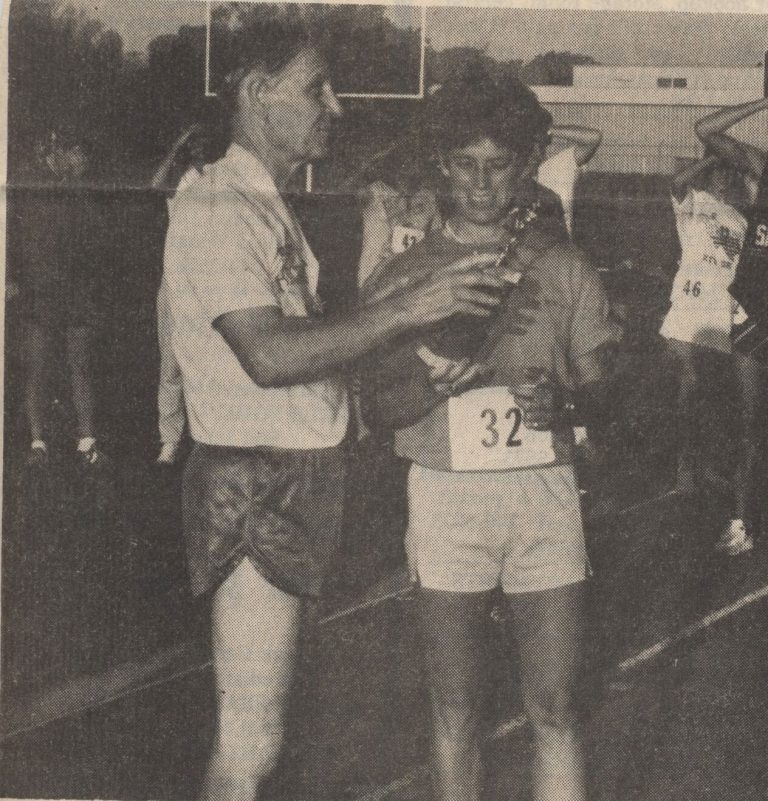Caylene Caddell, bib 32, receiving a trophy from Joe Nisbett as women's overall winner of the 5K Empty Saddle Run