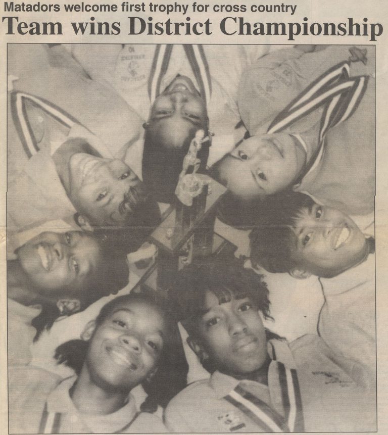 Seven Estacado cross country runners with the first district trophy, coached by Caylene Caddell, from the Estacado Echo