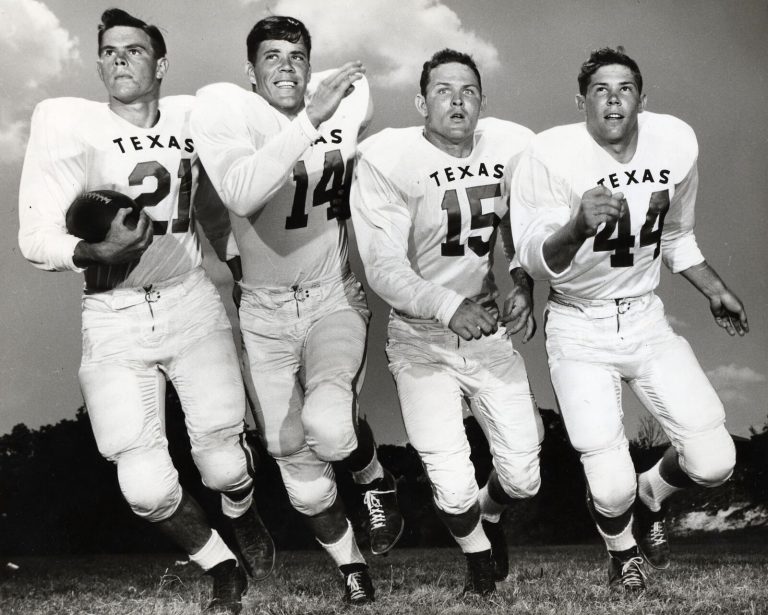 Charles Brewer, No. 21, running with a football beside three Texas teammates in a black-and-white photo