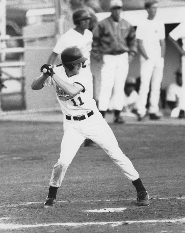 Clint Bryant gripping the bat in a batting stance at the plate in a black-and-white game photo
