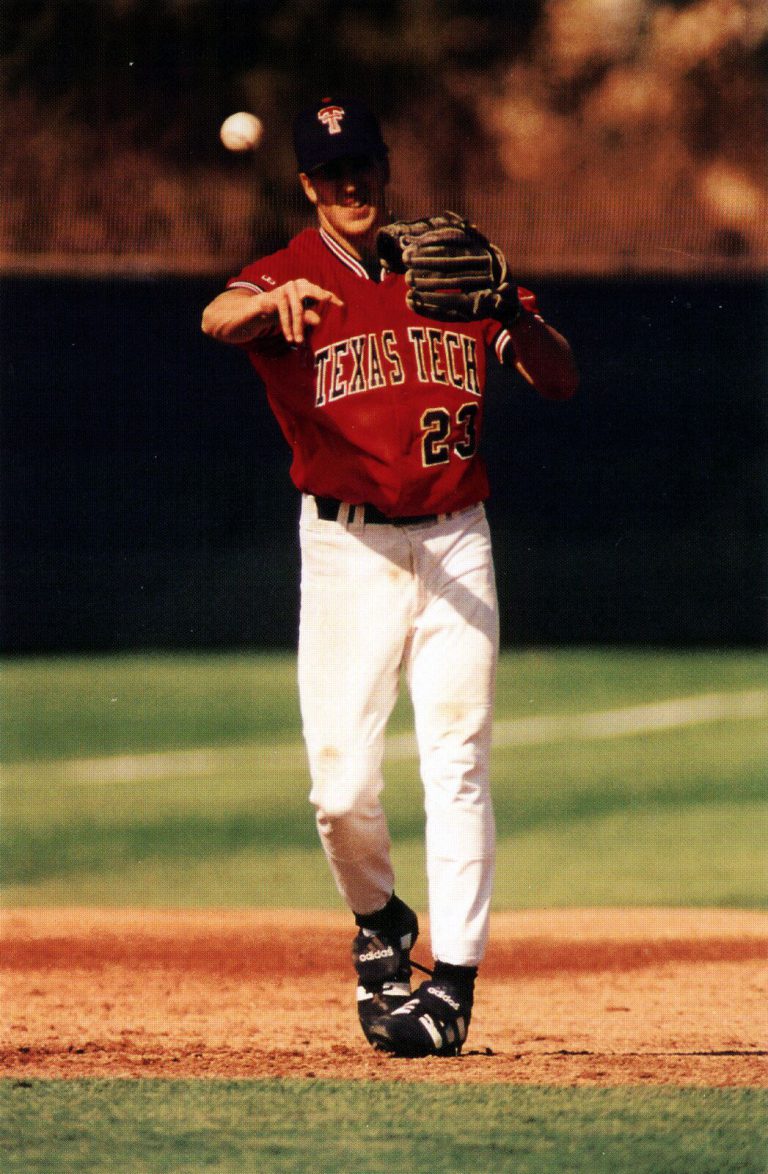 Clint Bryant in a red Texas Tech jersey on the field with glove raised