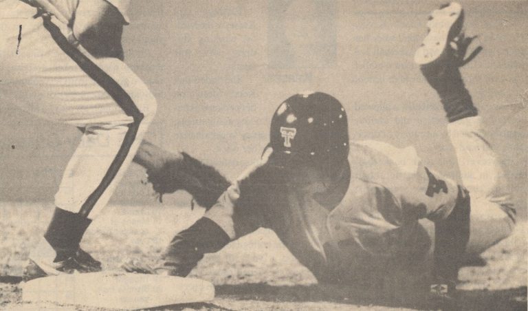 Clint Bryant sliding headfirst in a Texas Tech game, from a newspaper clipping titled Ducking the tag