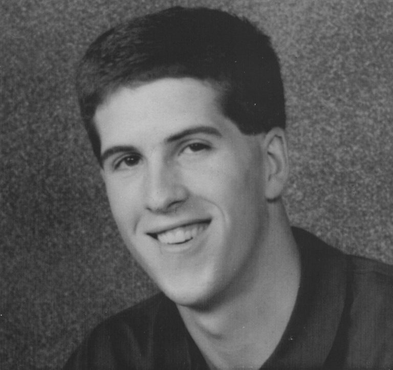 Clint Bryant smiling in a black-and-white portrait from a Mr. Monterey yearbook feature