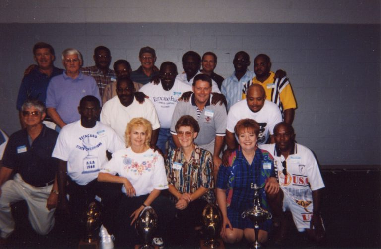 David Moody's 1968 Estacado state champion football team reunion group posing with trophies