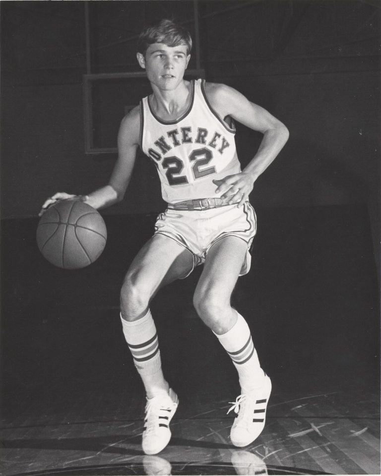 David Thetford dribbling a basketball in a Monterey number 22 uniform, black-and-white action pose