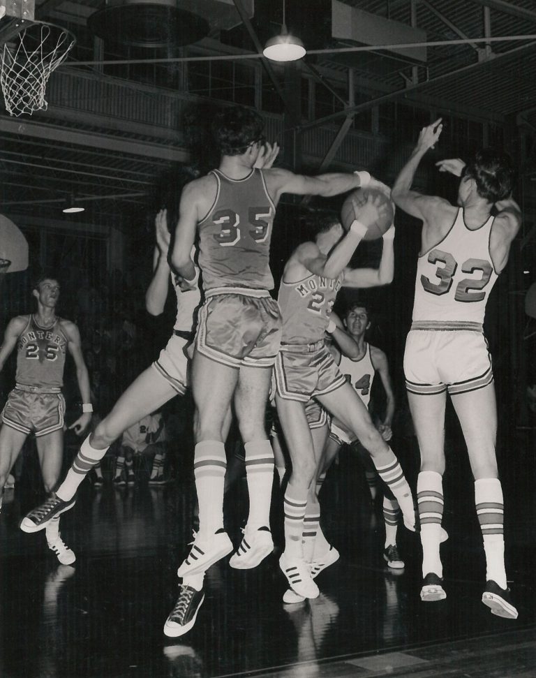 David Thetford in a Monterey number 23 jersey securing the ball amid leaping players during a game