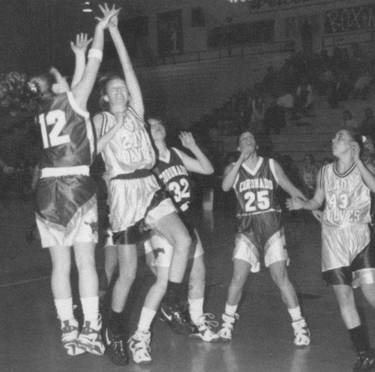 Erika Valek (12) rising for a jump shot against defenders in a Coronado game