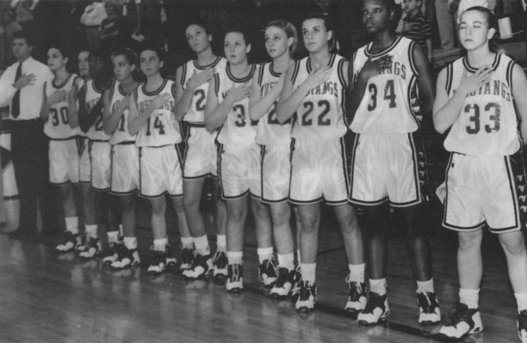 Erika Valek's Coronado Lady Mustangs teammates lined up with hands over hearts