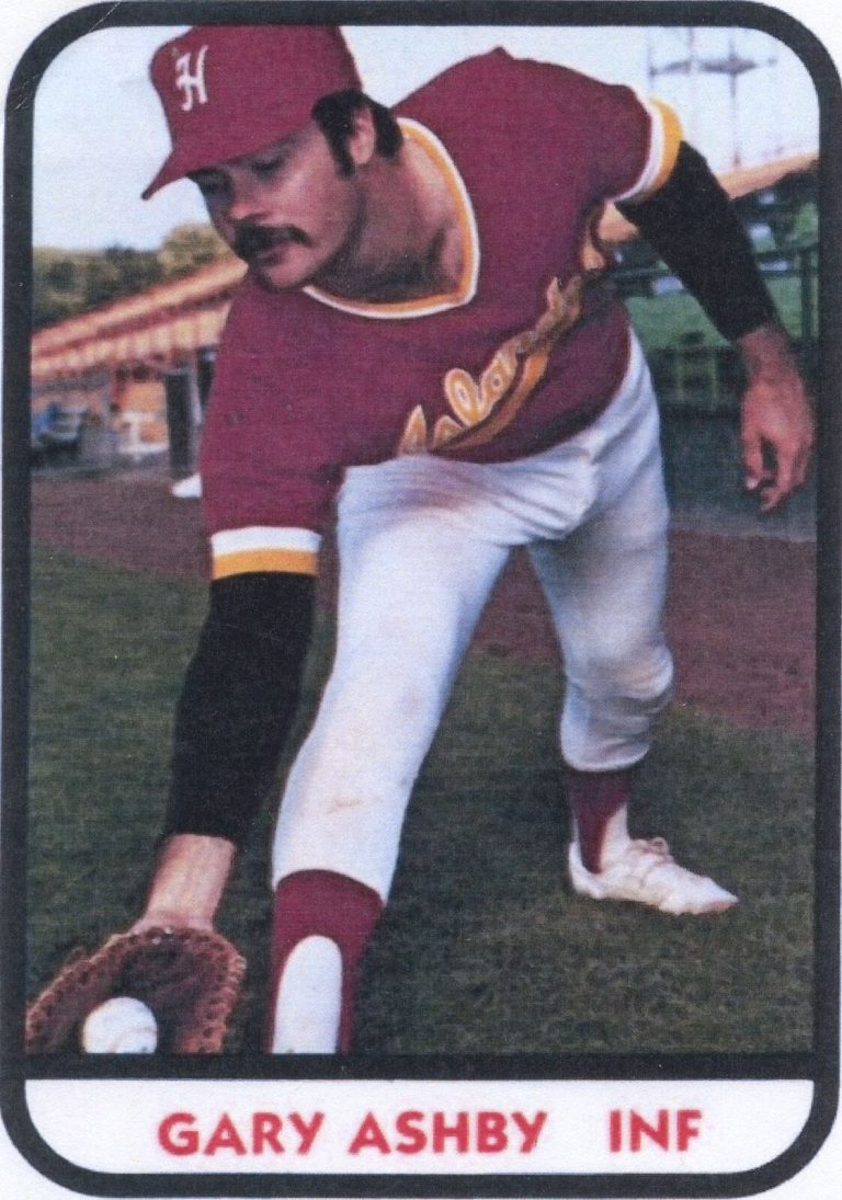 Gary Ashby on a baseball trading card, reaching down to field a ground ball in a maroon uniform and cap