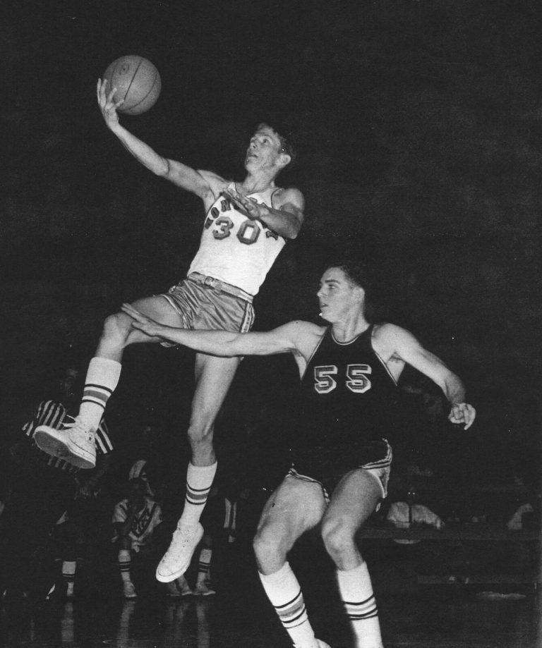 Gerald Myers' Monterey Plainsmen player leaping for a layup past a defender, black-and-white yearbook photo