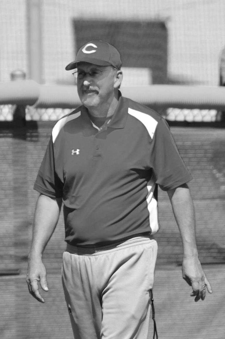 J. J. Johnson walking on a ballfield in a cap with a C logo, black-and-white portrait