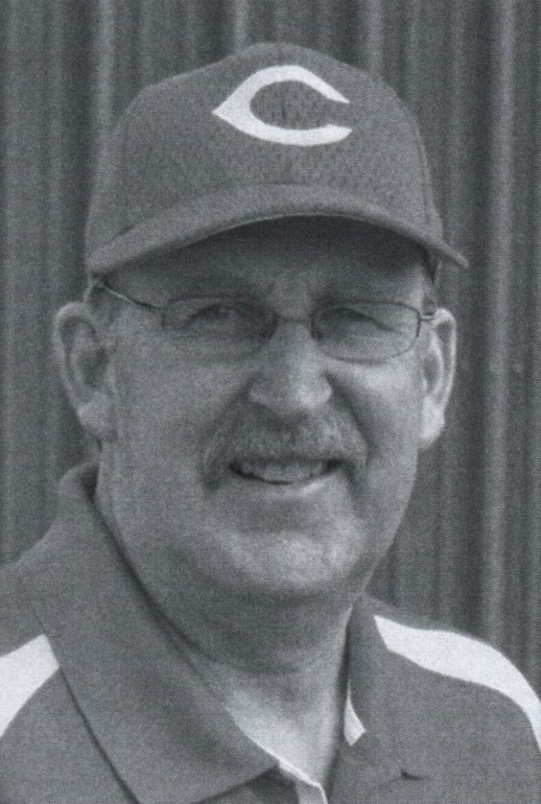 J. J. Johnson smiling in a cap with a C logo and wire glasses, black-and-white headshot