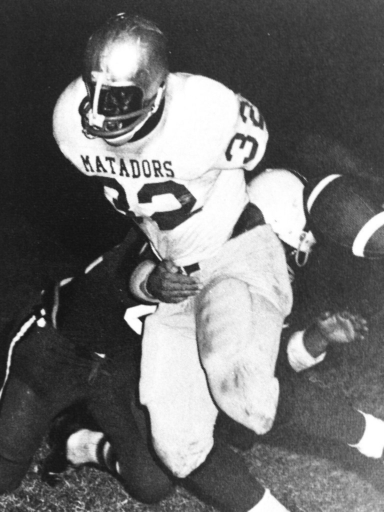 James Mosley, number 32 in a Matadors jersey, carrying the football in a black-and-white game photo