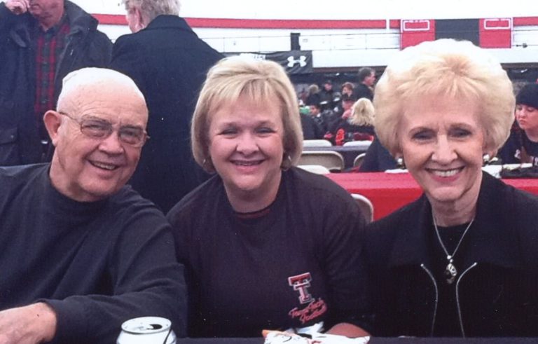 James Odom with two women at a Texas Tech game