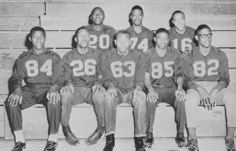 Dunbar teammates of James Ray Jackson seated in a row in numbered jerseys