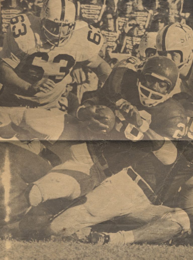 James Ray Jackson tackled by K-State defenders, from a newspaper clipping