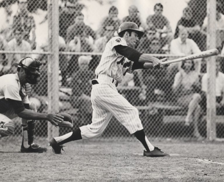 Jerry Haggard swinging a bat in a Texas Tech baseball game, black and white