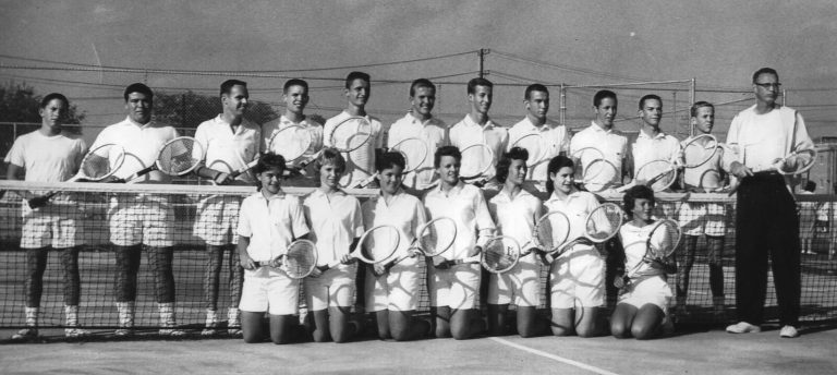 Jill Philbrick Gentry's tennis team posed in two rows at the net with rackets