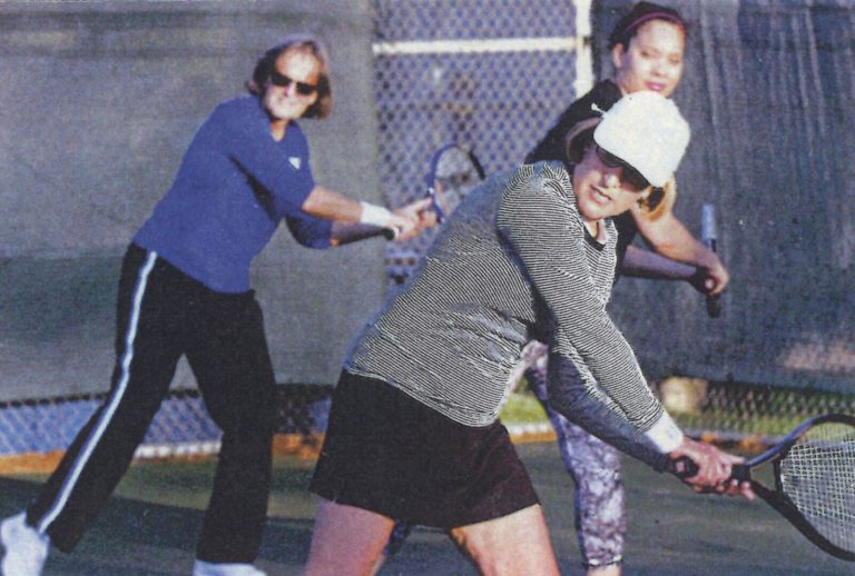 Jill Philbrick Gentry playing doubles tennis in a color photo