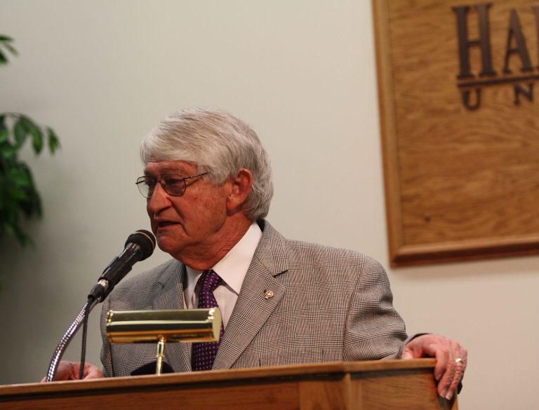 Jimmie Keeling speaking at a podium during retirement remarks