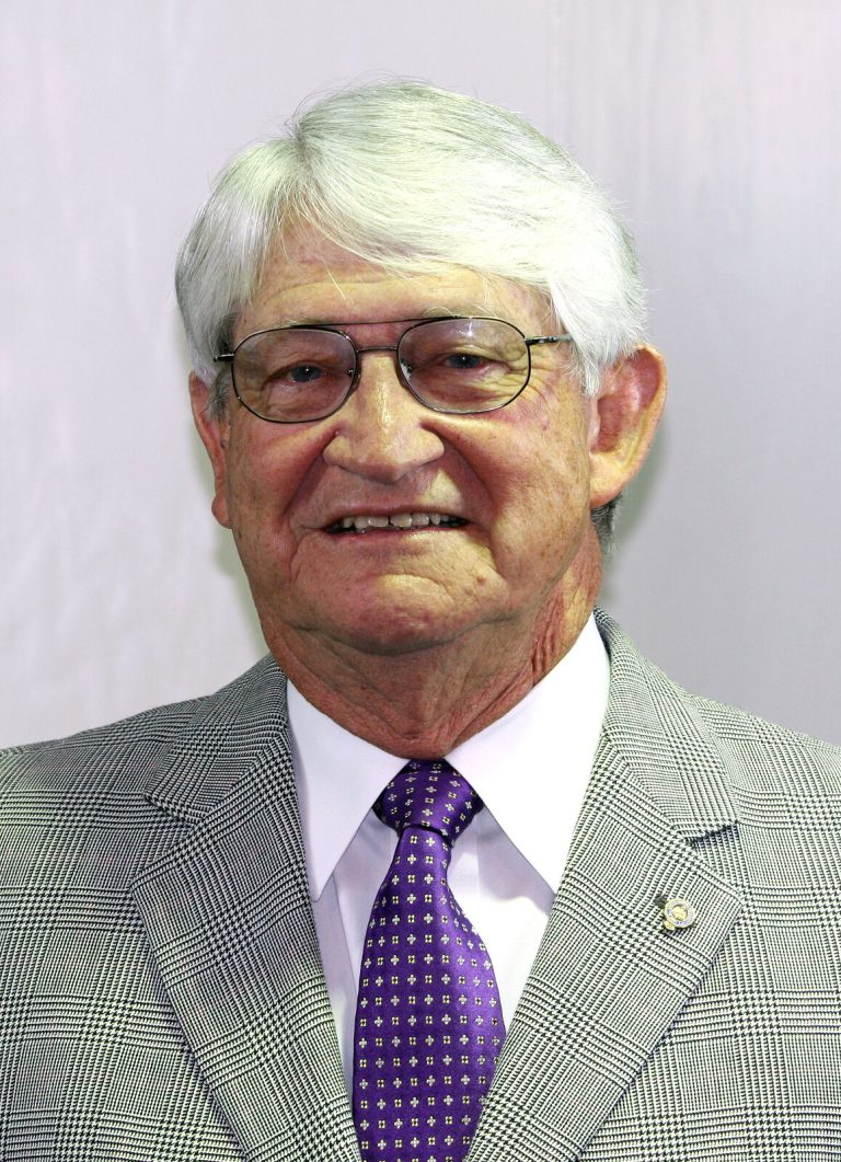 Jimmie Keeling in a gray sport coat and purple tie, formal portrait