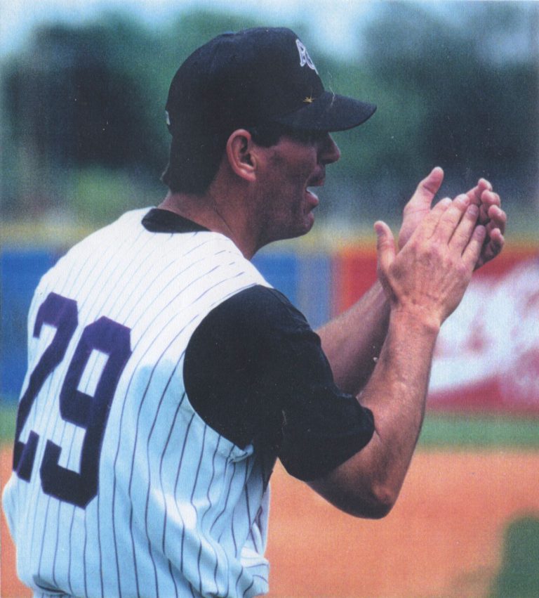 Jimmy Shankle, No. 29 head coach, applauding in an Abilene Christian University pinstripe jersey, 1996