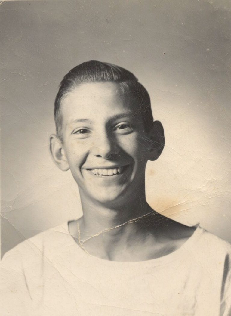 Joe Michalka as a smiling boy in a white shirt, in a studio portrait