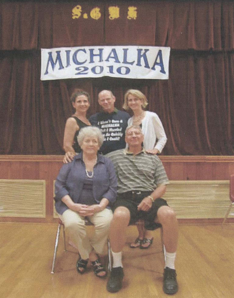 Joe Michalka's family posed together under a Michalka 2010 banner