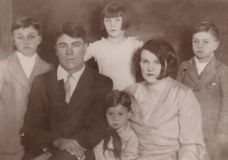Vintage sepia family portrait of a man, a woman and four children, from the John Cardinal family photos
