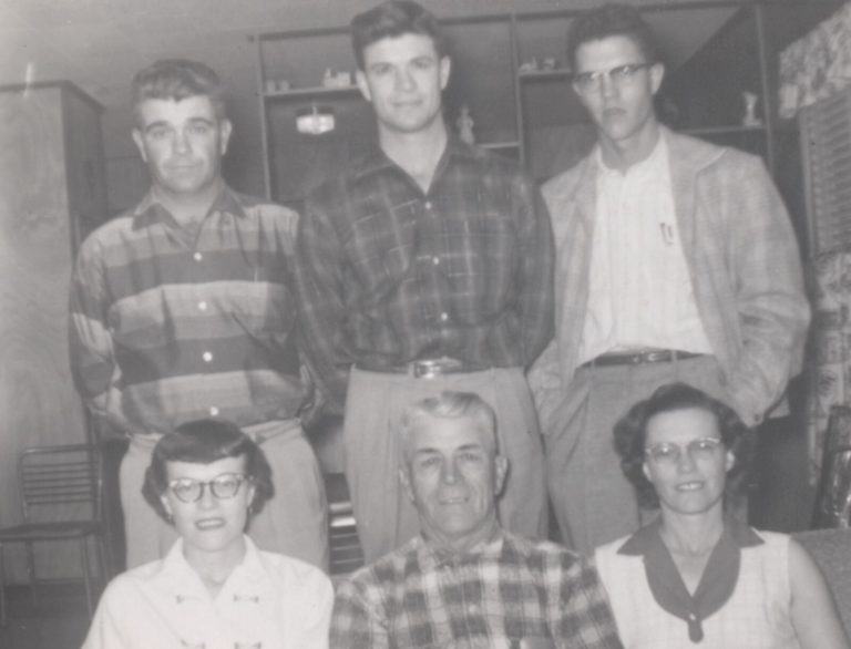 Family of six posed indoors, three young men standing behind three older adults, from the John Cardinal family photos