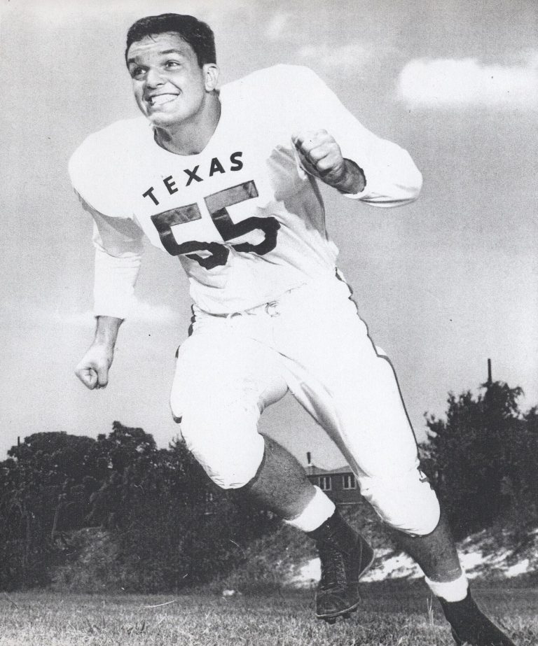 Johnny Tatum in a Texas number 55 jersey running with fists clenched and a big grin