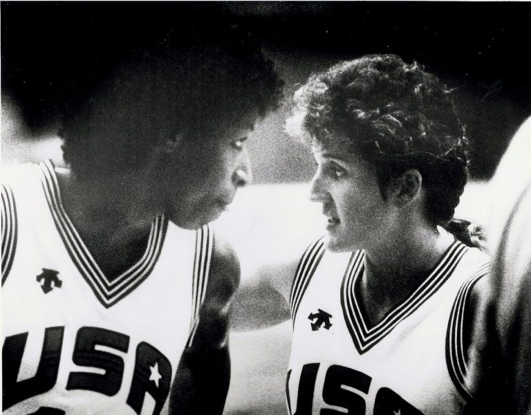 Two USA basketball players in white jerseys talking face to face, from Kamie Ethridge's collection