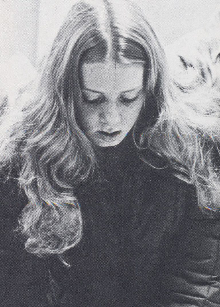 Kathy Kuhne Vick as a young woman with long hair looking down, black and white