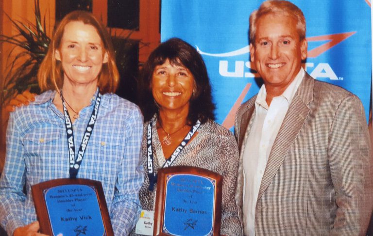 Kathy Kuhne Vick, left, holding a USPTA Doubles Player of the Year plaque beside Kathy Barnes and a man